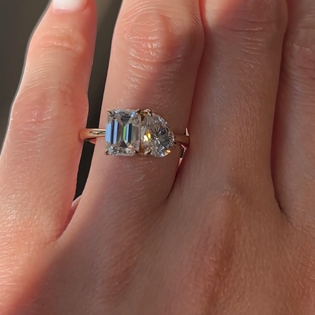 Close-Up of Emerald and Pear Moissanite Ring under Natural Light