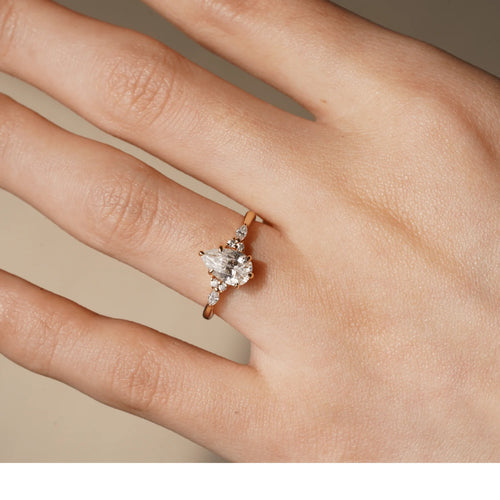 Pear Moissanite Ring on Hand Model with Sparkle