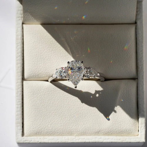 Pear Shaped Moissanite Ring with Two Side Stones